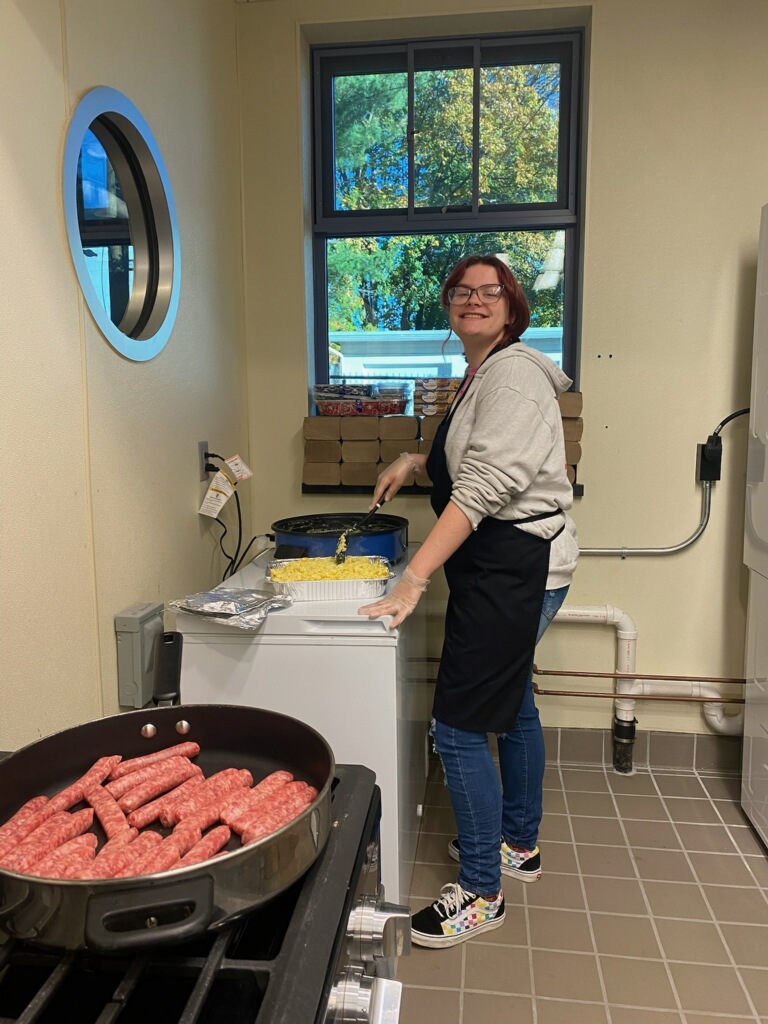 Cheyenne helping prepare a group meal in the kitchen